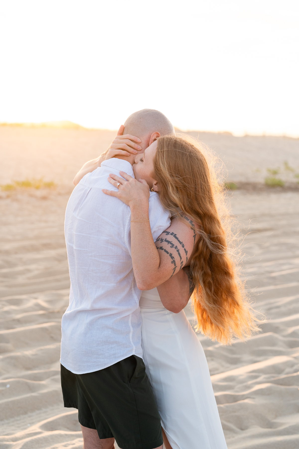 Newly engaged Delaware couple embracing in a passionate hug